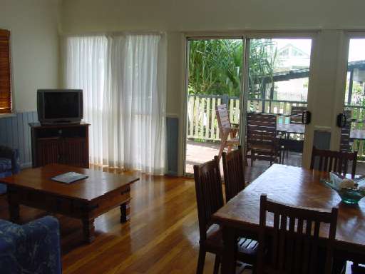 Another photo of Lounge/TV and dining rooms with view to deck and pool/BBQ area.